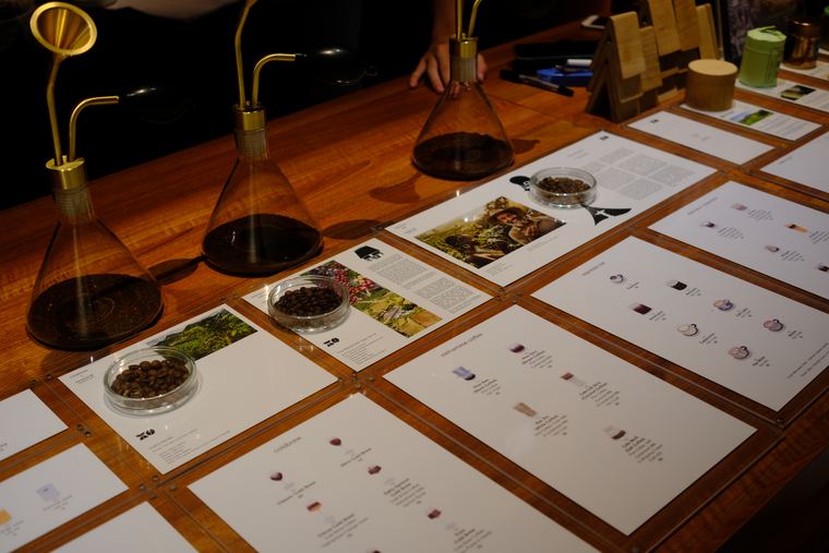 A coffee tasting flight laid out along a wooden bar