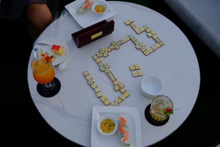 Dominoes and small plates on a round white table