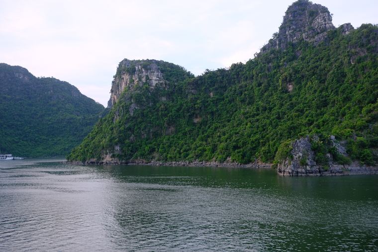 Limestone cliffs above green water in Ha Long Bay