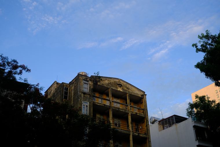 A weathered colonial building against a blue sky