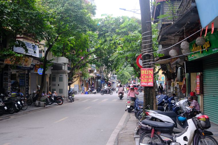A Hanoi street lined with parked motorbikes